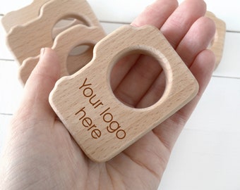 Bulk newborn photographer client gift . Personalized wood camera teether with logo wholesale