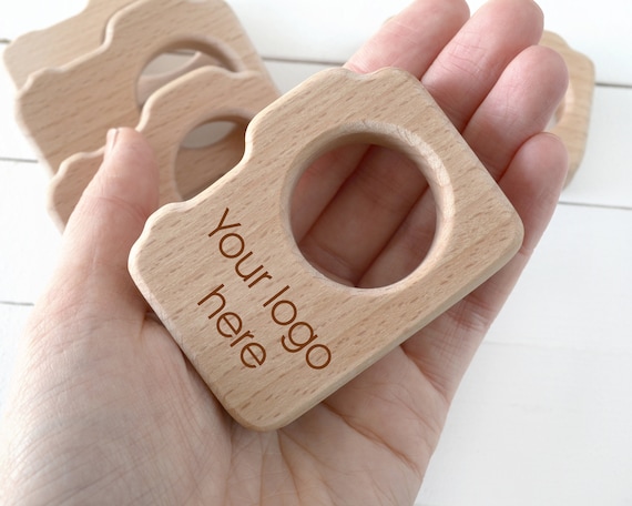 Bulk newborn photographer client gift . Personalized wood camera teether with logo wholesale