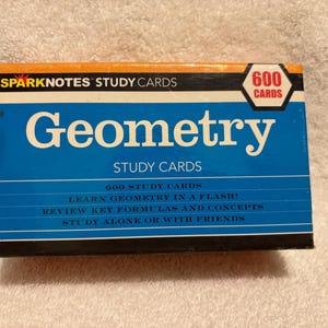 May include: A blue box of "Geometry" study cards from SparkNotes. The box has a white and orange top with the text "SPARKNOTES STUDY CARDS". The box contains 600 study cards and includes text such as "Learn Geometry in a Flash!"