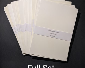 May include: A full set of bright white Arches 100% cotton hot press watercolor paper. The paper is stacked in a fan shape, with a white band across the front. The text "Arches Bright White 100% Cotton Hot Press" is printed on the band. The words "Full Set" are printed at the bottom.