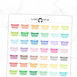 May include: A sheet of colorful plastic basket stickers. The stickers are in various colors, including pink, blue, green, yellow, and orange. The stickers are arranged in a grid pattern. The text "PLANNER PENGUIN" is at the top of the sheet.