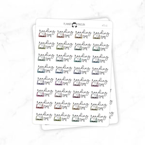 May include: White sticker sheets with multiple "reading time" graphics. Each graphic features an open book with a heart and the words "reading time" in a handwritten font. The books are in various colours, including red, orange, green, and purple.