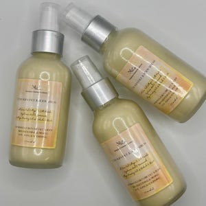 May include: Three bottles of Collagen Face & Body Serum with silver spray tops and cream-colored liquid. Each bottle has a label with text, including "Hydration for entire face & body" and "Anti-aging & nourishing."
