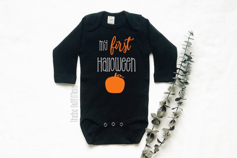 May include: Black long-sleeve baby onesie with the text "my first halloween" and an orange pumpkin graphic.
