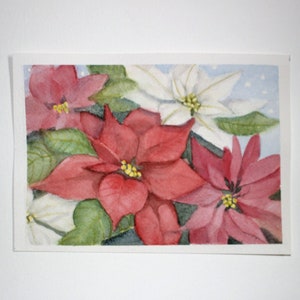 Original watercolor painting on textured acid free paper of red, white and pink poinsettia flowers. This colorful floral picture was painted in a 5x7 inch horizontal format. Touches of green leaves are interspersed between the flowers. Holiday theme.