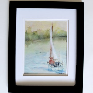 May include: A watercolor painting of a sailboat on a lake with a person in a red shirt at the helm. The background is a soft green and yellow.