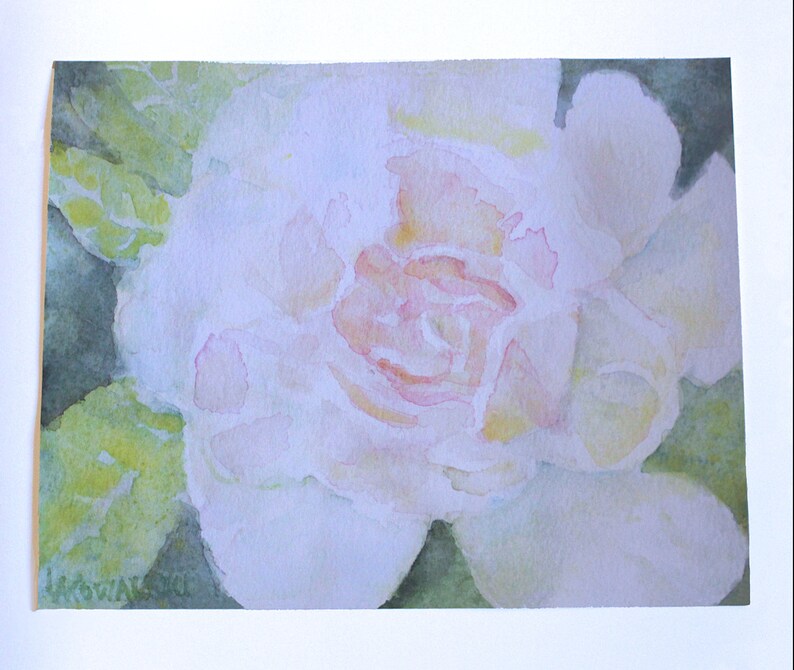 A watercolor fine art print of a white rose flower accented with pinks and peach. The flower is surrounded by green leaves. The painting is signed 'L. A. Kowalski' in the bottom left corner. Horizontal format, 16x20 Inch size on textured fine art paper.