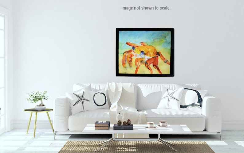 Colorful fine art print of Sally Lightfoot crab watercolor. Hangs in a horizontal format.  It is displayed in a neutral toned living room above a sofa.  Vibrant colors of reds, oranges and blue dominate the picture.  Printed on textured  art paper.