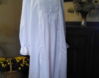 May include: A white long-sleeved nightgown with a lace trim and a button-up front. The nightgown has a gathered waist and a flowing skirt.