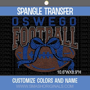 May include: A spangle transfer design featuring the text OSWEGO FOOTBALL in blue and brown rhinestones. Below the text is a brown football with a blue bow. The design measures 10.6 inches wide by 8.9 inches high. The background is black.