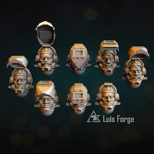Puede incluir: Una colección de nueve cabezas en miniatura de resina gris con varios diseños de cascos, algunos con viseras levantadas o bajadas, y auriculares. Cada cabeza muestra rasgos faciales distintos. El texto Luis Forge es visible en la esquina inferior.