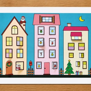 May include: A colorful illustration of three houses against a blue sky with a yellow crescent moon. The buildings feature festive details including a Santa in a chimney, a snowman, a Christmas tree, wrapped gifts, and various holiday ornaments.