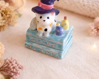 Handmade witch cat figurine: Ceramic Halloween decoration, Kitten statue on spell books