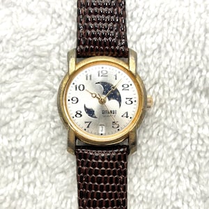 May include: A set of three ceramic mugs with a speckled, matte finish. The mugs are in shades of cream, light gray, and dark gray. Each mug has a simple, minimalist design, perfect for coffee or tea.