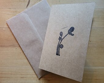 May include: A blank brown card with a brown envelope. The card has a black fern design printed on it.