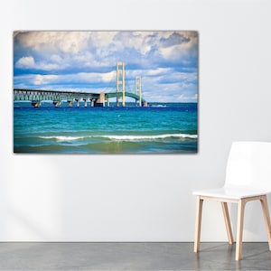 May include: A photograph of the Mackinac Bridge in Michigan, with blue water and a cloudy sky in the background.
