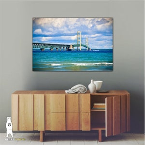 May include: A photograph of the Mackinac Bridge in Michigan, with blue water and a cloudy sky in the background.