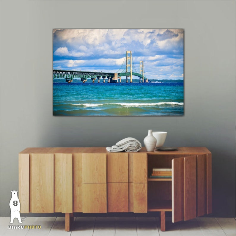 May include: A photograph of the Mackinac Bridge in Michigan, with blue water and a cloudy sky in the background.