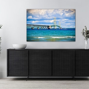 May include: A photograph of the Mackinac Bridge in Michigan, with blue water and a cloudy sky in the background.