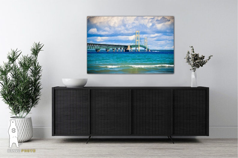 May include: A photograph of the Mackinac Bridge in Michigan, with blue water and a cloudy sky in the background.