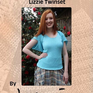 May include: A woman wearing a light blue knitted top with a white knitted shrug and a plaid skirt. The image is titled "Machine Knitting Patterns Designer Knitwear Lizzie Twinset" and "By henio Handcrafted Designer Knitwear Pattern Series".