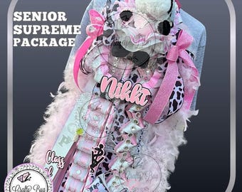 May include: A custom-made senior mum in pink, white, and black cow print. The mum features a plush cow, ribbons, and the name "Nikki". The text "Senior Supreme Package" and "Class of" are visible. The design includes feathers and bows.