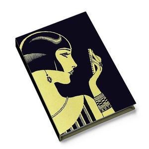 May include: A black and gold notebook cover with a vintage illustration of a woman looking in a mirror. The woman has short, dark hair and is wearing a pearl necklace and bracelets.