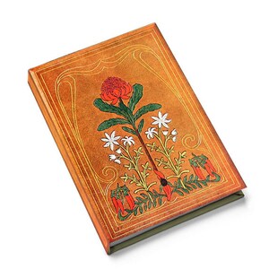 May include: A hardbound journal with a tan cover featuring a floral design. The cover has a decorative border and a central illustration of a red flower, white flowers, and green leaves. The edges of the journal are a darker tan color.