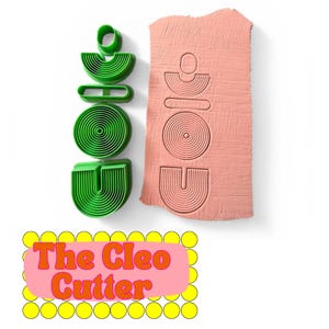 May include: Green polymer clay cutters in a geometric design next to a block of pink clay with the same design imprinted. The text "The Cleo Cutter" is displayed in a pink rectangle with yellow circles.