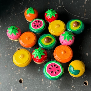 May include: Assortment of 12 colorful fruit-shaped drawer pulls with a variety of designs, including watermelon, strawberry, lemon, and pineapple.