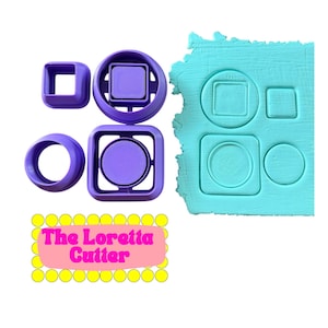 May include: A collection of purple cookie cutters in various shapes, including squares, circles, and a square with a circle inside. A piece of blue clay shows impressions of the shapes. The text "The Loretta Cutter" is displayed on a pink background.