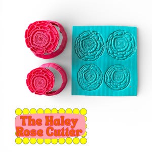 May include: A set of pink rose-shaped cookie cutters and a teal mold. The cutters are in the shape of a rose with detailed petal designs. The mold has four rose impressions. The text "The Haley Rose Cutter" is also visible.