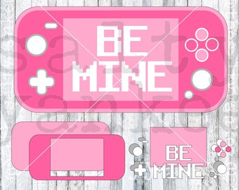 May include: Pink handheld game console with the words "BE MINE" in pixelated white letters on the screen. The console has a white plus sign and circle buttons.