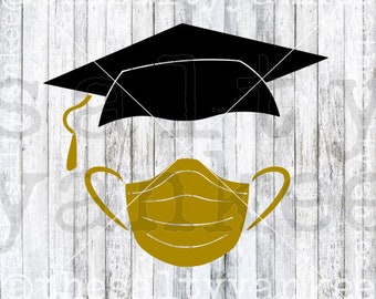 May include: A black graduation cap with a gold face mask. The cap is tilted to the side and the mask is centered below it.