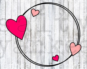 May include: A white wood background with a black circle frame and three pink and red hearts. The hearts are in different sizes and are placed around the circle frame.