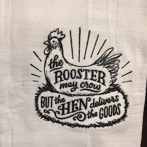 May include: Black and white embroidered kitchen towel with a rooster and the text "The rooster may crow but the hen delivers the goods."