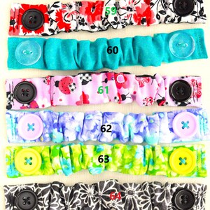 May include: A set of 10 fabric face mask extenders with different patterns and colors. The extenders have buttons on each end and are numbered 58 through 65.