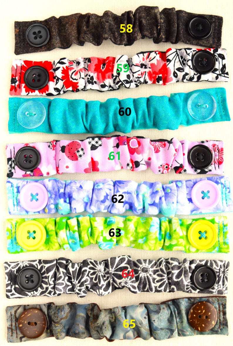 May include: A set of 10 fabric face mask extenders with different patterns and colors. The extenders have buttons on each end and are numbered 58 through 65.