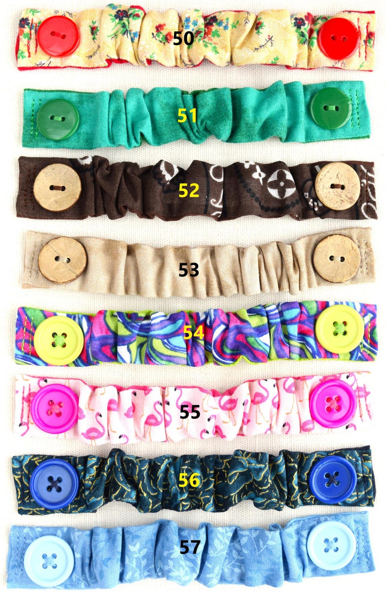 May include: Seven colorful fabric face mask extenders with different patterns and buttons. The extenders are numbered 50 through 57.