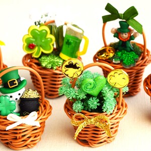 Puede incluir: Seis pequeñas cestas de mimbre decoradas con tréboles verdes, monedas de oro y figuritas en miniatura de duendes, osos y un muñeco de nieve. Las cestas están llenas de musgo verde y son perfectas para el Día de San Patricio.