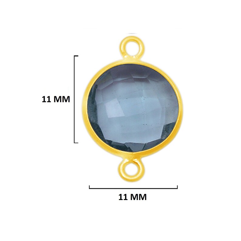 May include: Gold-toned pendant with a round, faceted, dark blue gemstone. The pendant measures 11 mm in diameter.