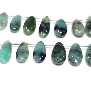 May include: A strand of emerald green gemstone beads in a teardrop shape. The beads are strung on a silver wire.
