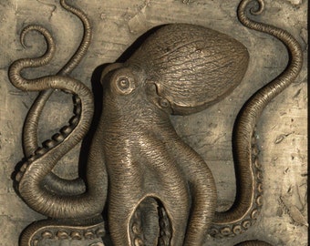 octopus, cold cast bronze high relief wall sculpture in white wooden frame