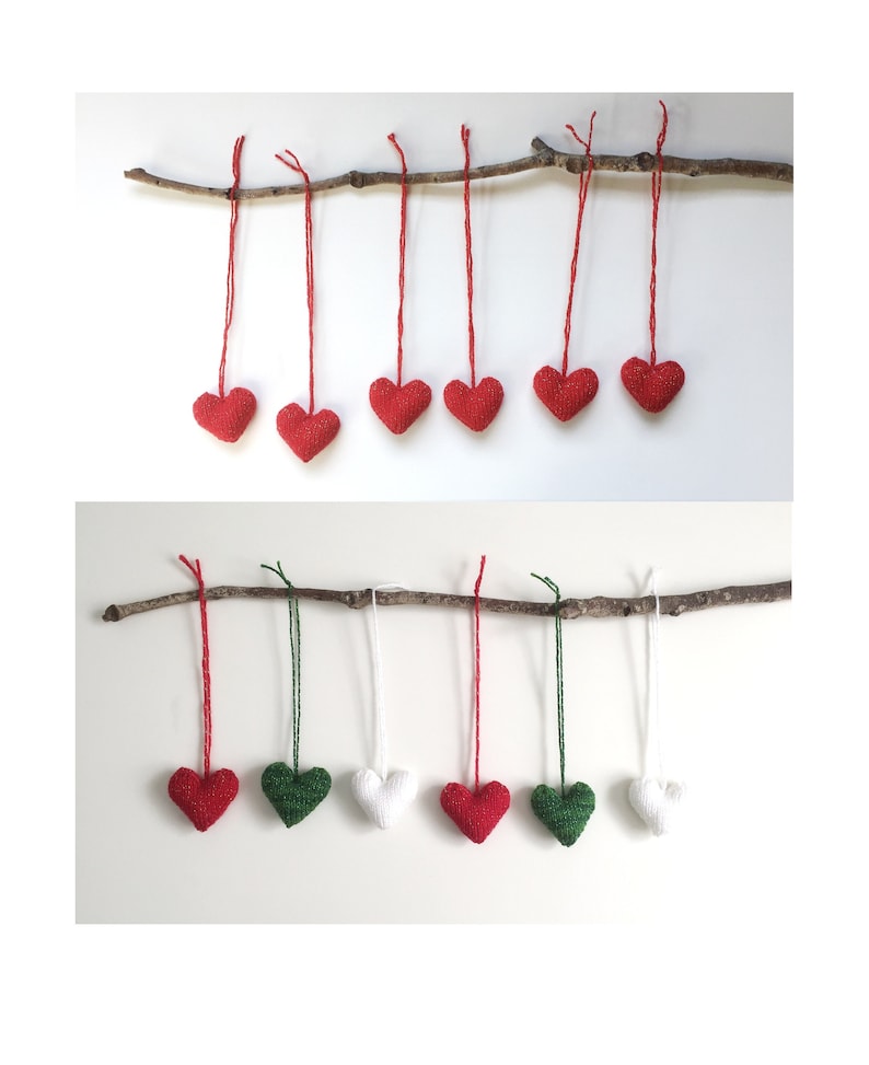 May include: A collection of heart-shaped ornaments in red, green, and white, suspended from a natural branch. The ornaments are made of a textured material and are hung by red, green, and white strings. The background is a plain white surface.