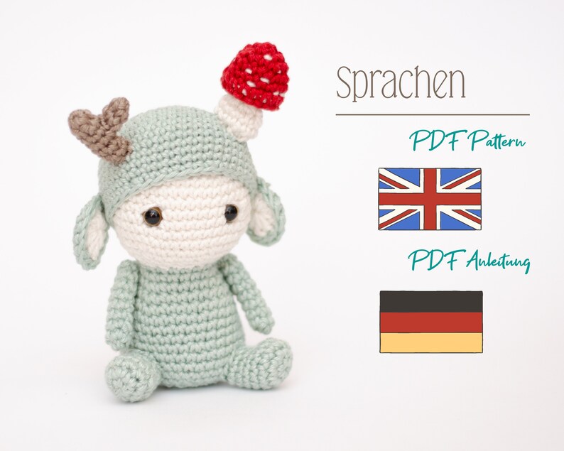 May include: A crocheted doll in a light green outfit with a mushroom hat and small antlers. The doll has a cream-colored face and large black eyes. The image also includes the text "Sprachen", "PDF Pattern", and "PDF Anleitung", along with the flags of the UK and Germany.