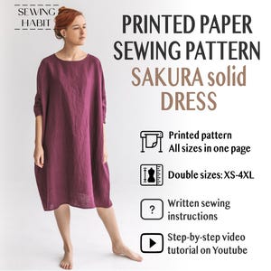 May include: A woman models a burgundy Sakura solid dress. The image features text: "PRINTED PAPER SEWING PATTERN" and "SAKURA solid DRESS". The pattern offers double sizes XS-4XL, printed instructions, and a video tutorial.