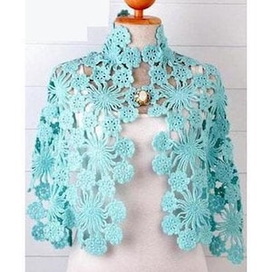 May include: A light blue crocheted shawl with a floral design. The shawl has a high neckline and is open in the front.
