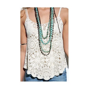 May include: A white crocheted tank top with a layered turquoise and brown beaded necklace.