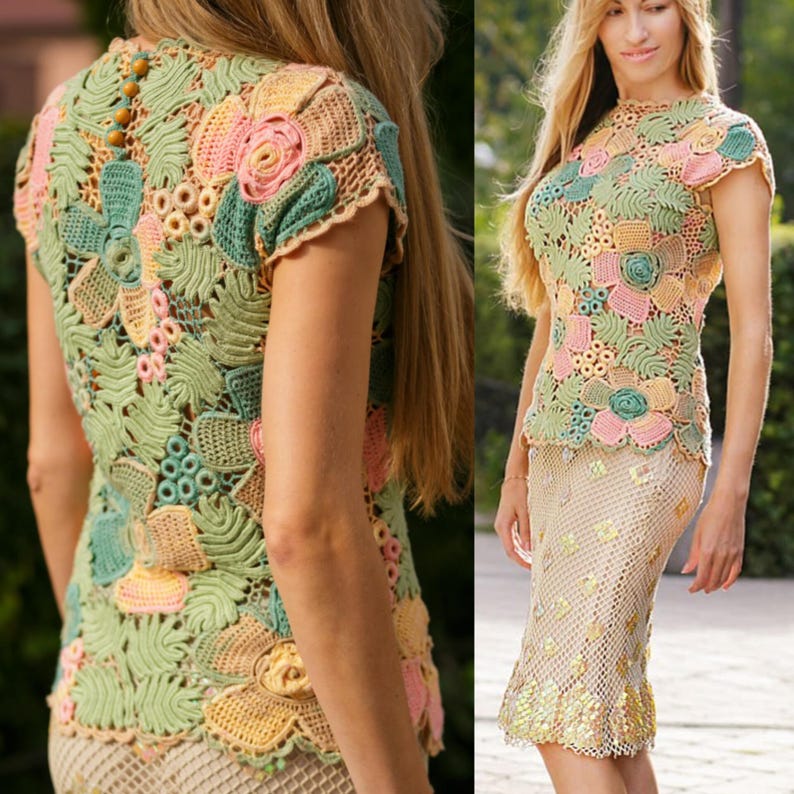 May include: A crocheted top with a floral design in shades of green, pink, and yellow. The top has short sleeves and a round neckline.