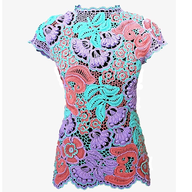 May include: A crocheted top with a floral design in shades of pink, purple, and turquoise.